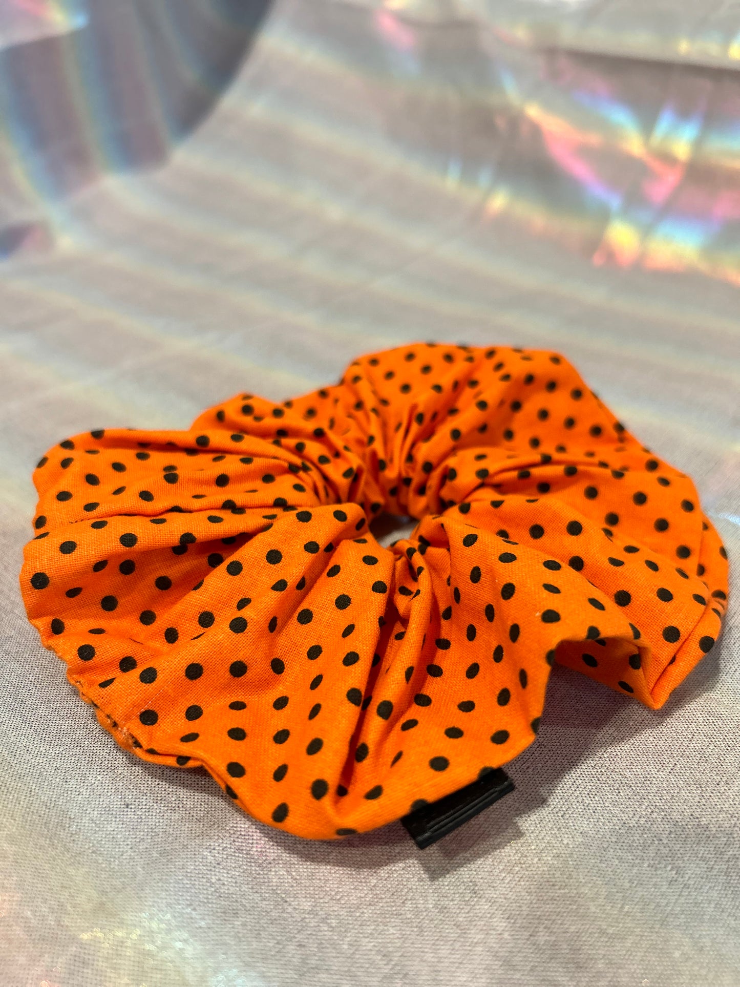 Large orange and black polka dot scrunchie